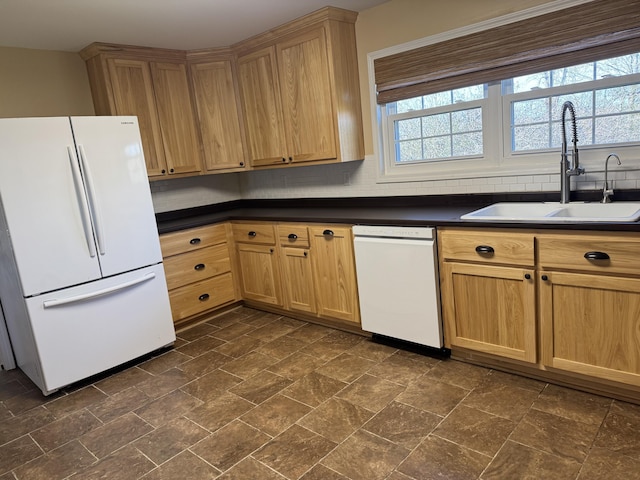 kitchen featuring sink, backsplash, and white appliances