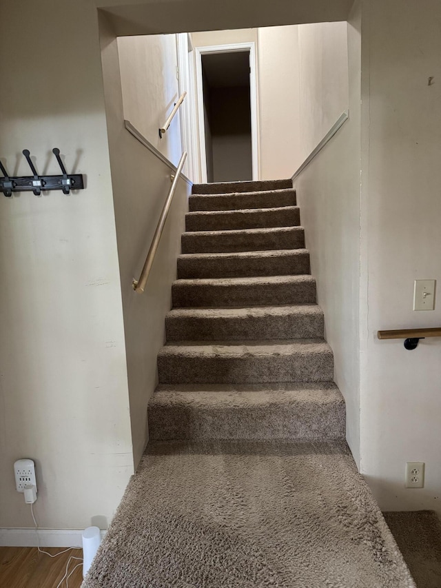 stairway featuring hardwood / wood-style floors