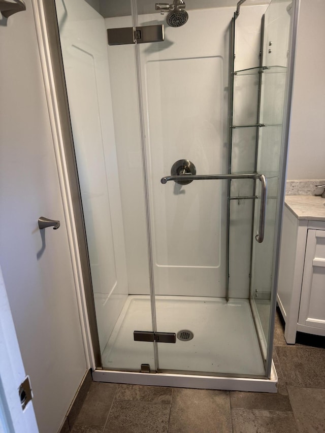 bathroom with vanity and a shower with door