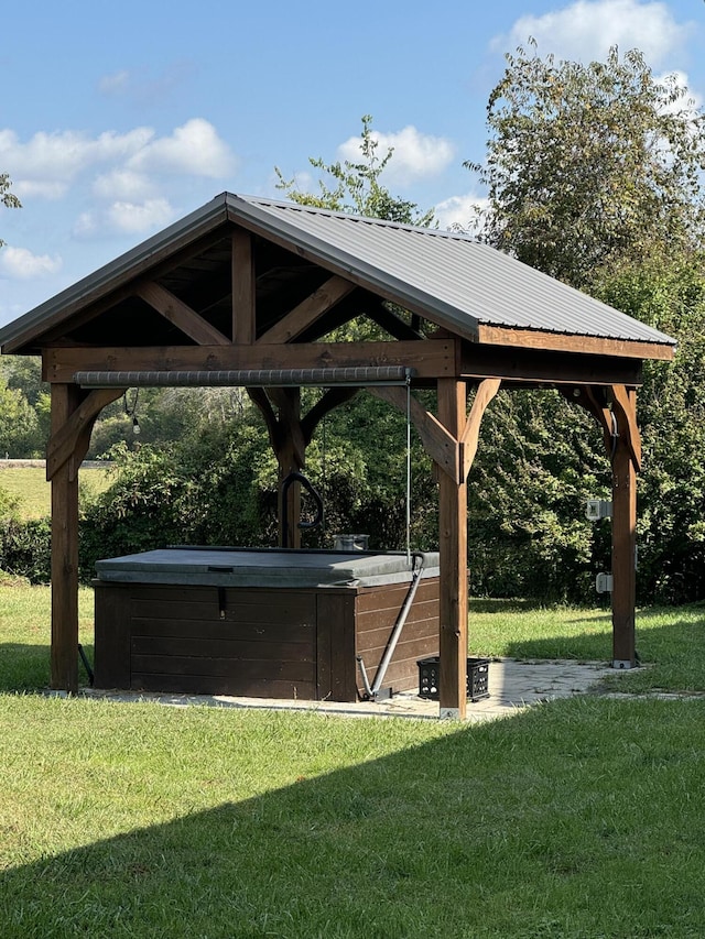 view of community with a gazebo, a hot tub, and a yard