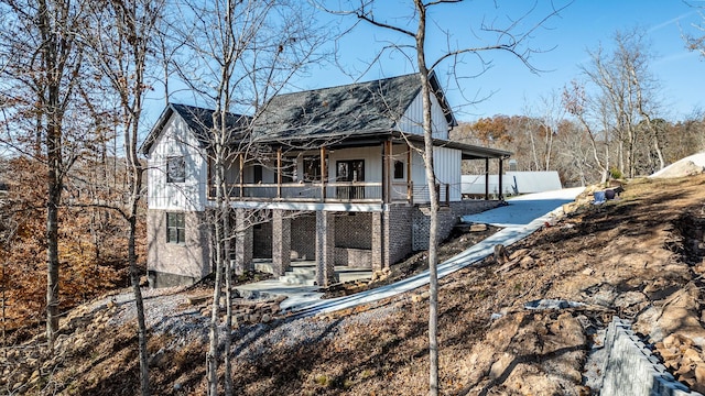 view of home's exterior with a porch and a balcony