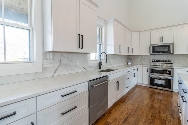 kitchen with white cabinetry, sink, a healthy amount of sunlight, and appliances with stainless steel finishes