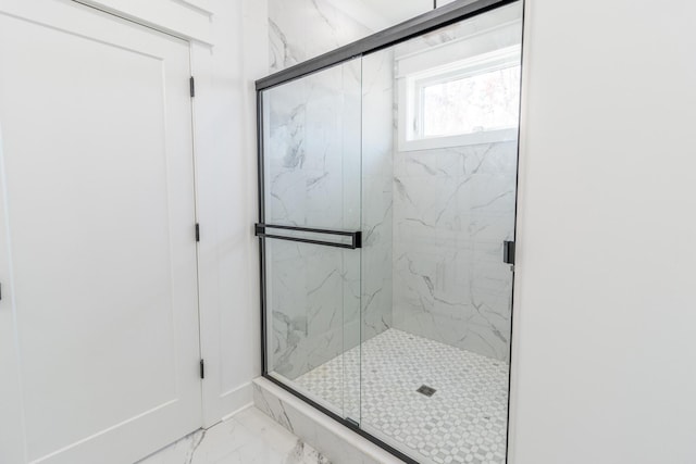 bathroom with a shower with shower door