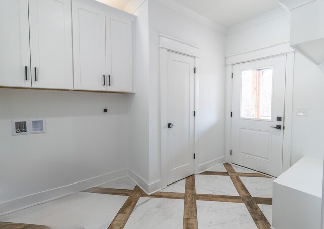 laundry room with electric dryer hookup, cabinets, crown molding, and hookup for a washing machine