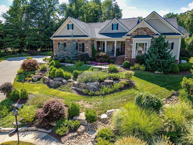 craftsman-style house featuring a porch and a front yard