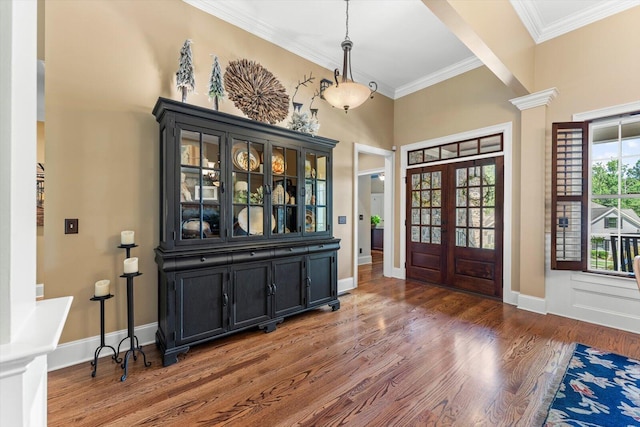 entrance foyer featuring crown molding, dark wood-type flooring, french doors, and ornate columns