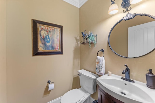 bathroom featuring vanity, ornamental molding, and toilet