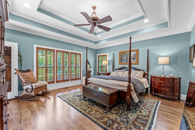 bedroom with ceiling fan, ornamental molding, and a raised ceiling