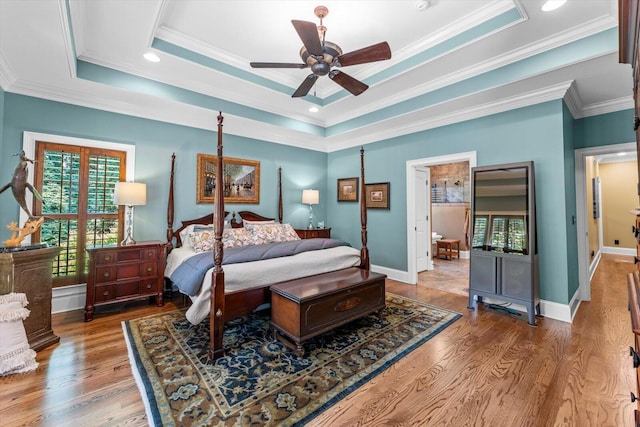 bedroom with a tray ceiling, ornamental molding, and ceiling fan