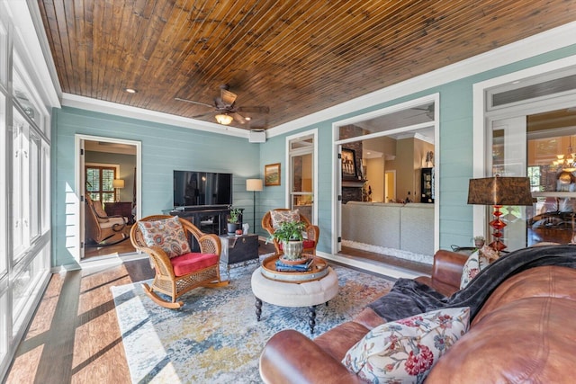 sunroom with wooden ceiling and ceiling fan