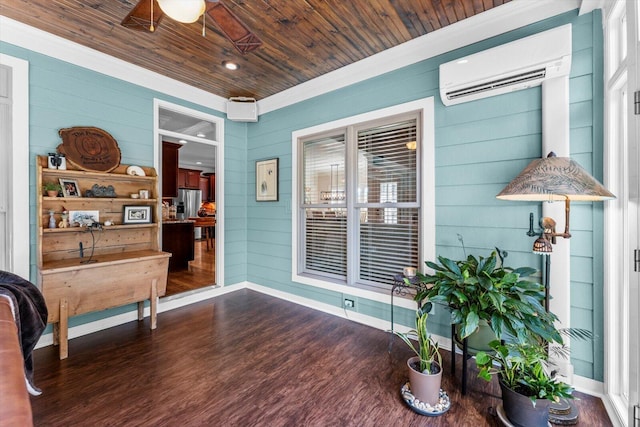 sitting room with wood ceiling, hardwood / wood-style flooring, ceiling fan, wooden walls, and an AC wall unit