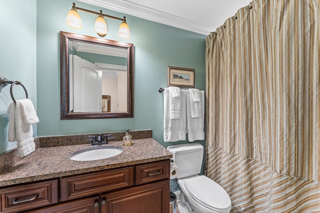 bathroom featuring crown molding, vanity, and toilet