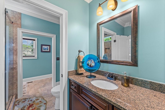 bathroom featuring vanity, crown molding, and toilet