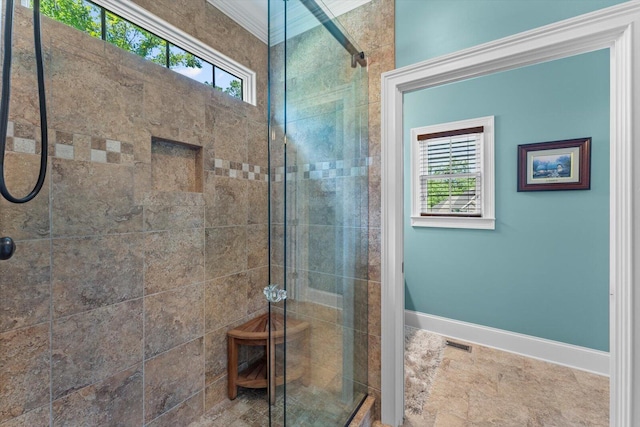 bathroom featuring plenty of natural light and a shower with shower door