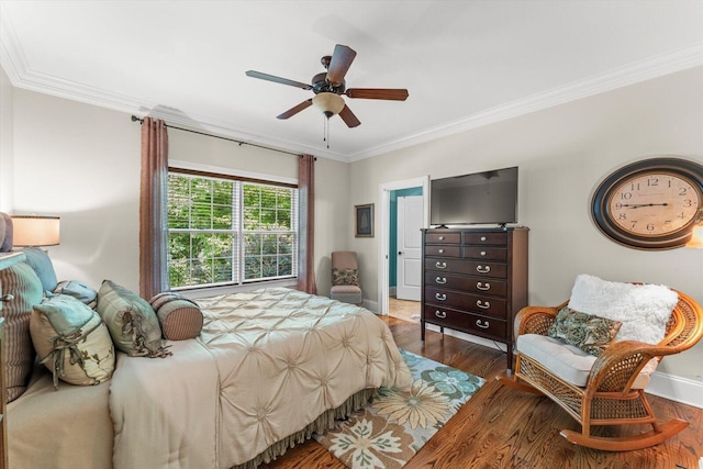 bedroom with crown molding, dark hardwood / wood-style floors, and ceiling fan