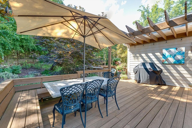 wooden deck with grilling area and a pergola