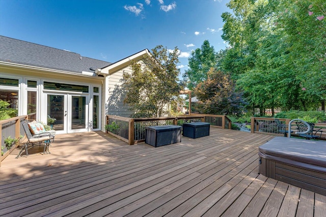 wooden deck featuring french doors and a covered hot tub