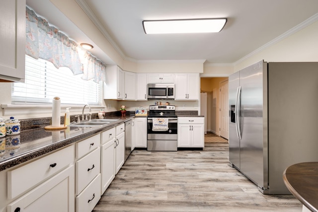 kitchen featuring white cabinetry, sink, appliances with stainless steel finishes, and light hardwood / wood-style flooring