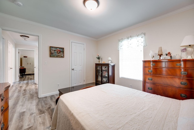 bedroom featuring light hardwood / wood-style flooring and ornamental molding