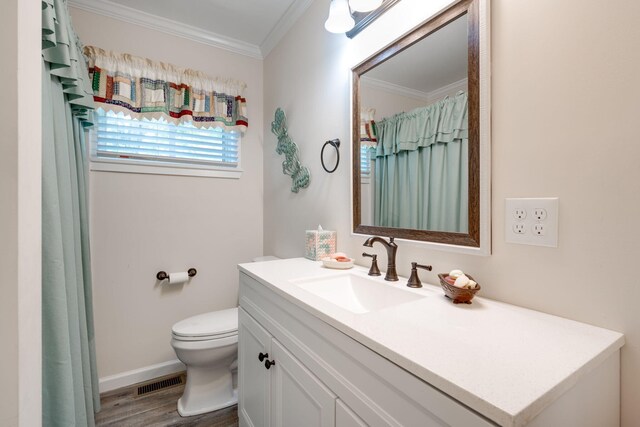 bathroom with wood-type flooring, vanity, toilet, and ornamental molding