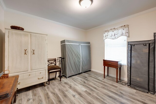 interior space with light wood-type flooring and crown molding