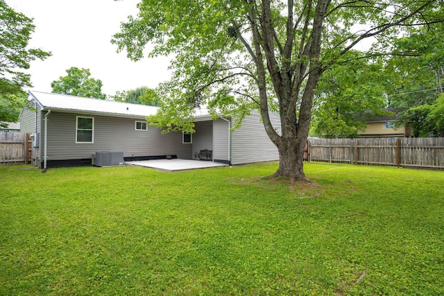 back of property featuring central AC, a yard, and a patio