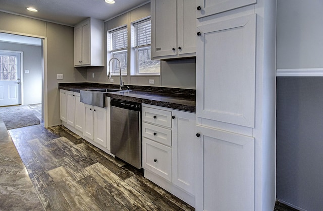 kitchen featuring a wealth of natural light, sink, white cabinets, dark hardwood / wood-style flooring, and stainless steel dishwasher