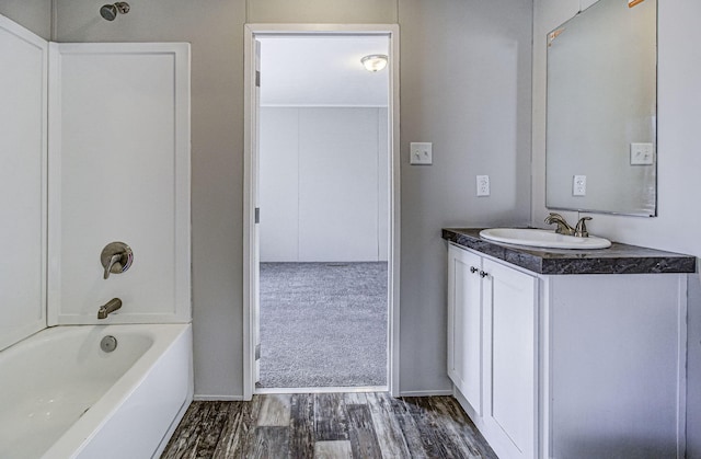 bathroom with hardwood / wood-style flooring, vanity, and bathtub / shower combination