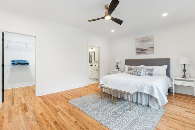 bedroom with ceiling fan, light wood-type flooring, and a closet