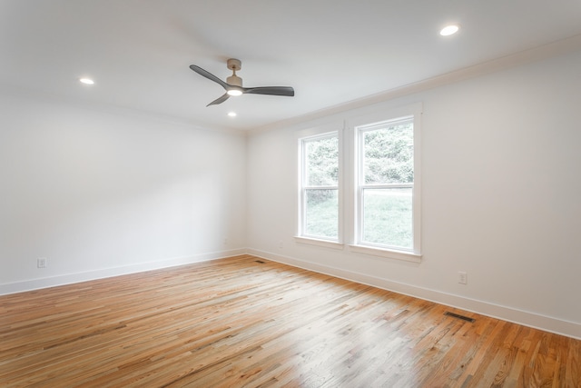 empty room with ceiling fan, light hardwood / wood-style flooring, and crown molding