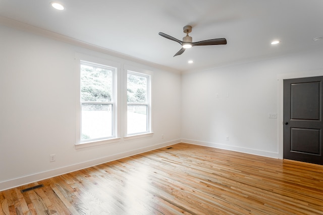 spare room featuring ceiling fan, light wood-type flooring, and crown molding