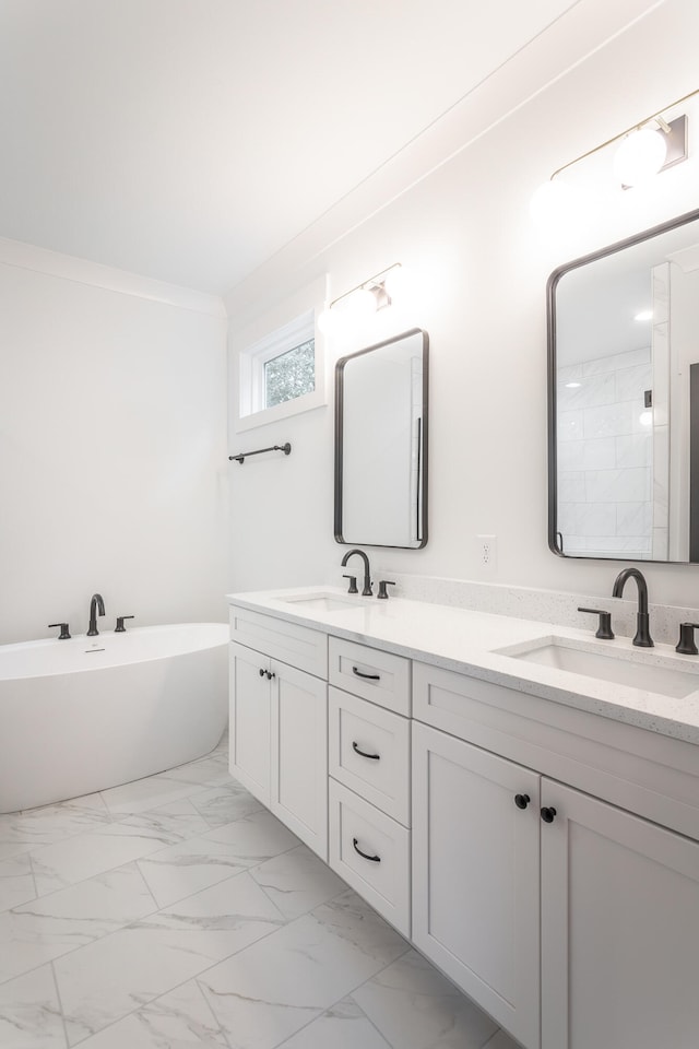 bathroom with ornamental molding, vanity, and a bathing tub