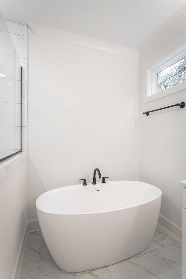 bathroom with a tub and vanity