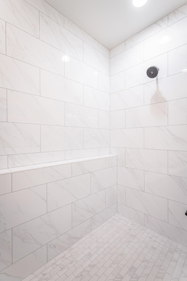 bathroom with a tile shower