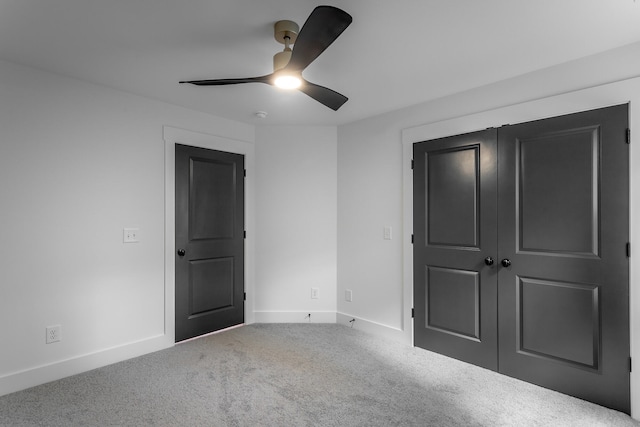 unfurnished bedroom featuring carpet, ceiling fan, and a closet