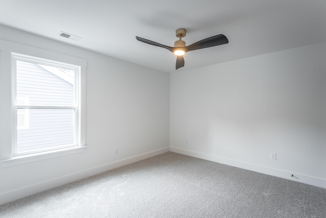 empty room featuring carpet flooring and ceiling fan