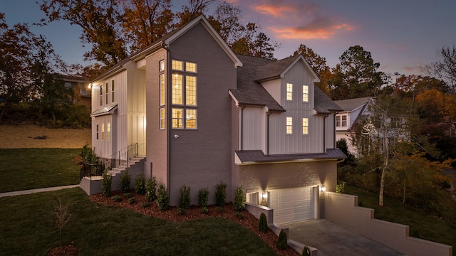 exterior space featuring a garage and a yard