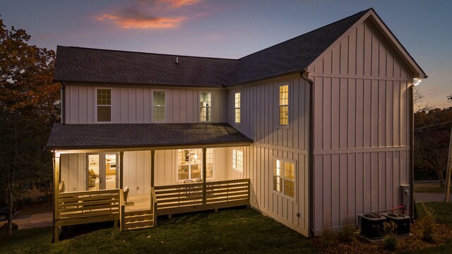 back house at dusk with a porch