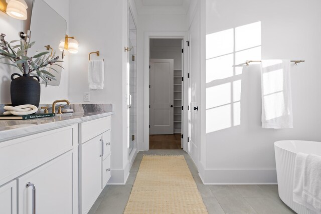 bathroom featuring tile patterned floors, vanity, and shower with separate bathtub