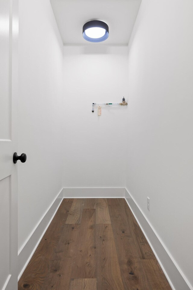 laundry room with dark wood-type flooring