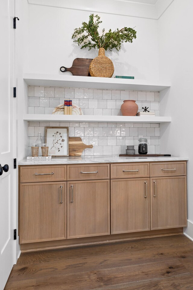 bar featuring dark hardwood / wood-style floors and decorative backsplash