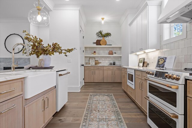 kitchen featuring dark hardwood / wood-style floors, pendant lighting, white appliances, light brown cabinetry, and custom range hood