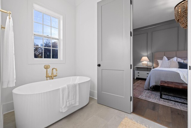 bathroom with a washtub and hardwood / wood-style floors