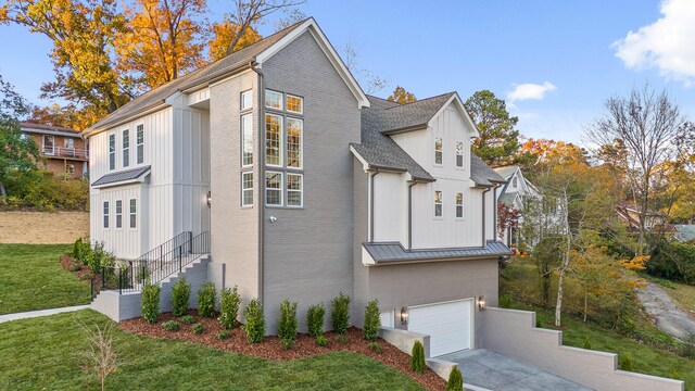 view of side of property with a lawn and a garage