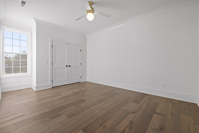 unfurnished bedroom with a closet, ceiling fan, hardwood / wood-style floors, and crown molding