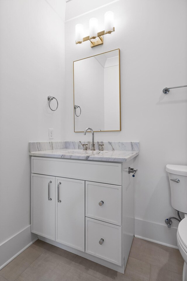 bathroom with vanity and toilet