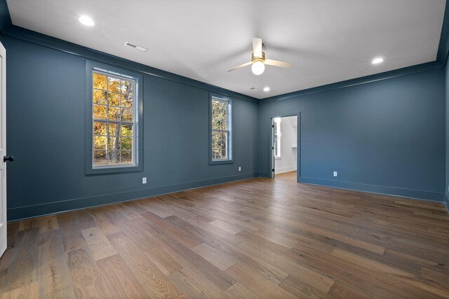 spare room with ceiling fan, wood-type flooring, and ornamental molding