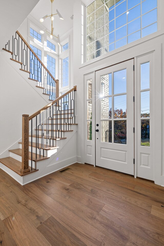 entrance foyer with wood-type flooring and a high ceiling