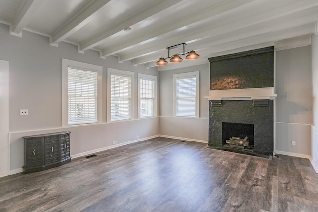 unfurnished living room featuring beam ceiling, a premium fireplace, and dark wood-type flooring