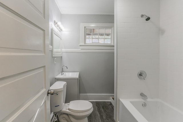 full bathroom with toilet, wood-type flooring, vanity, and tiled shower / bath combo